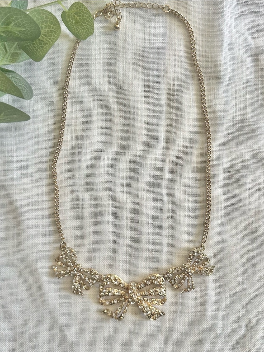 Gold-toned multi-bow rhinestoned statement necklace